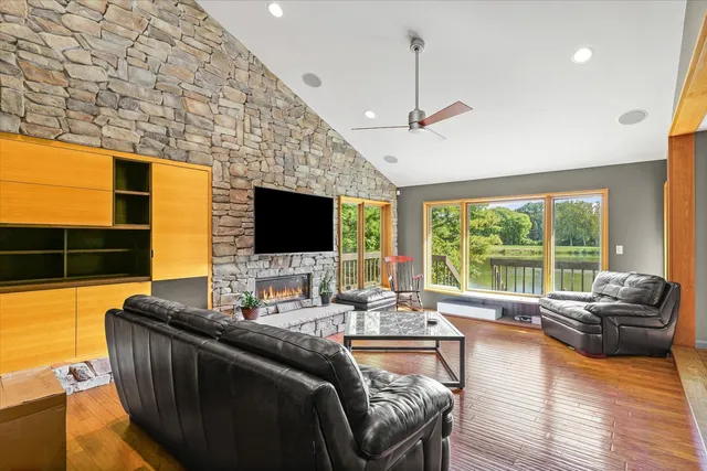 a living room with furniture fireplace and flat screen tv