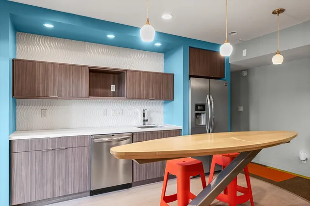 a view of a house with a yard deck and a large tree