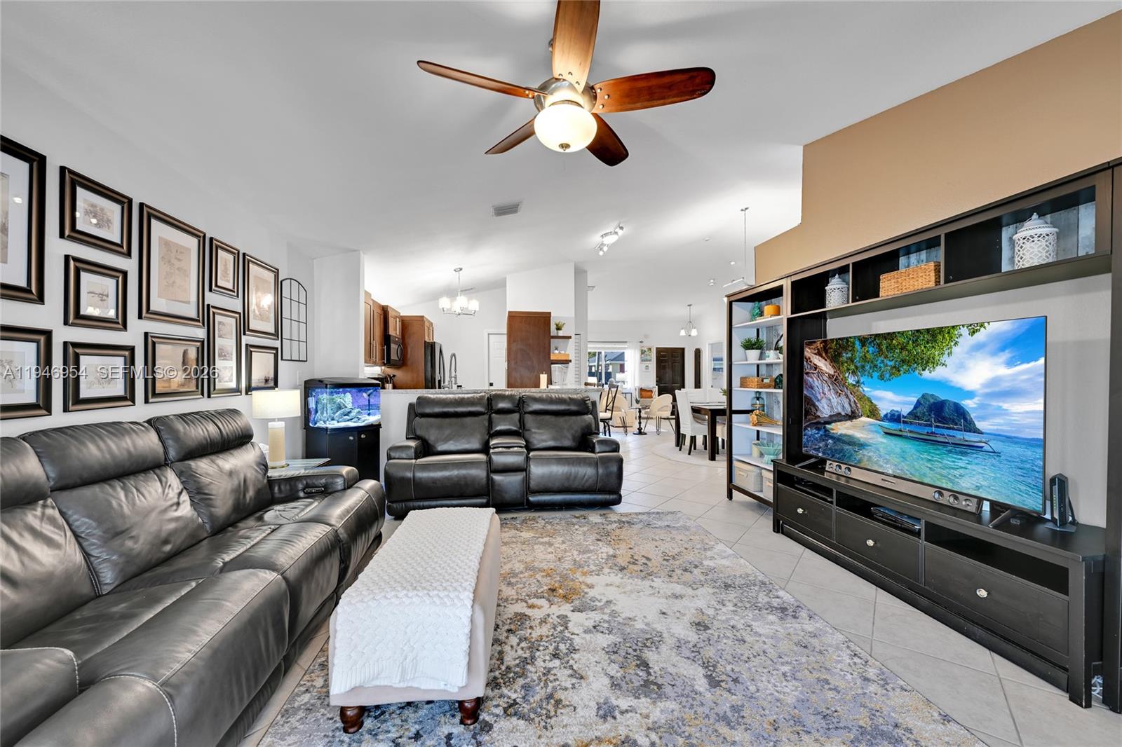 24955 Southwest 129th Path Homestead, FL 33032 - Photo 11 of 26 a living room with furniture and a flat screen tv