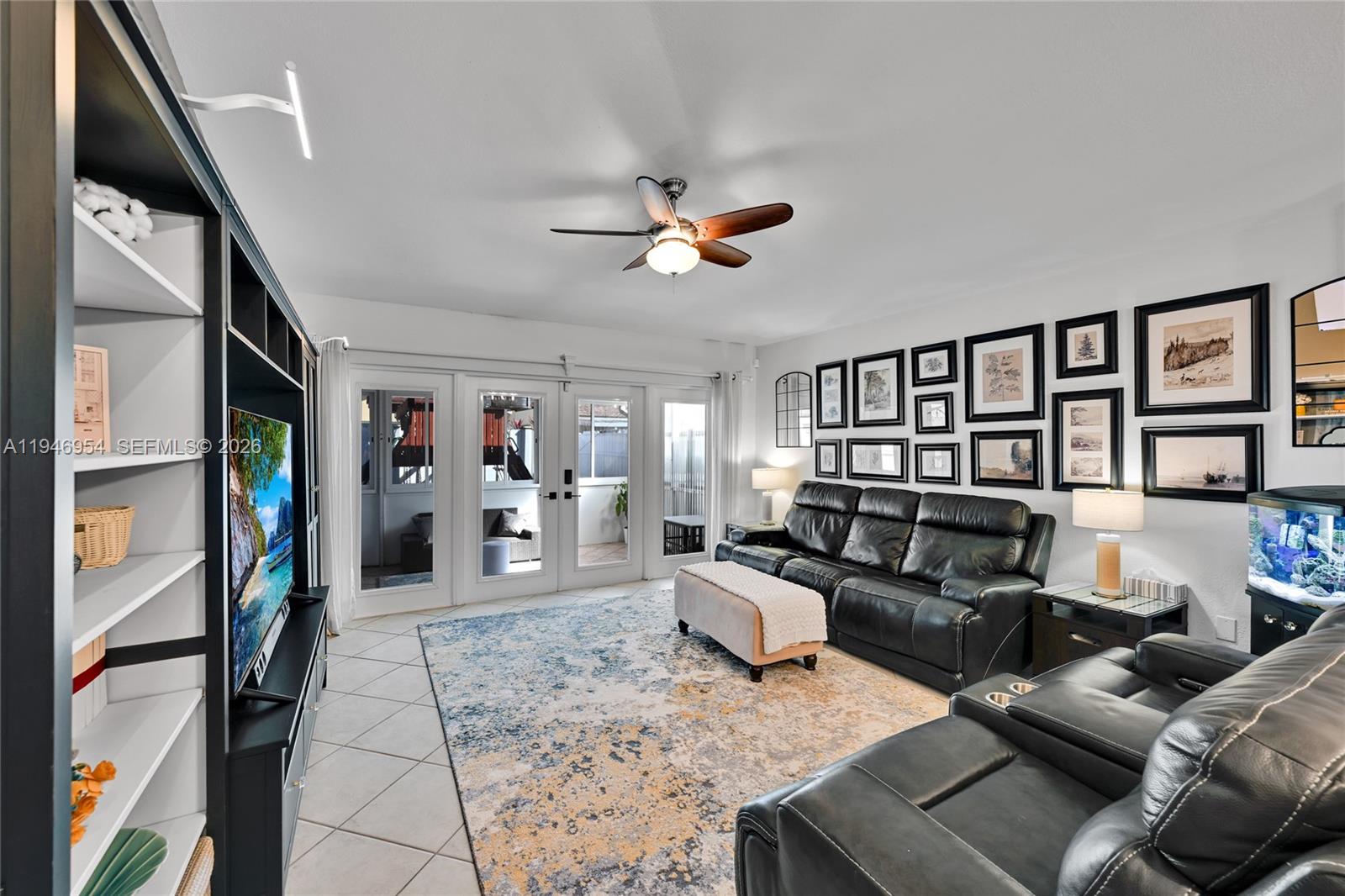 24955 Southwest 129th Path Homestead, FL 33032 - Photo 12 of 26 a living room with furniture and a flat screen tv