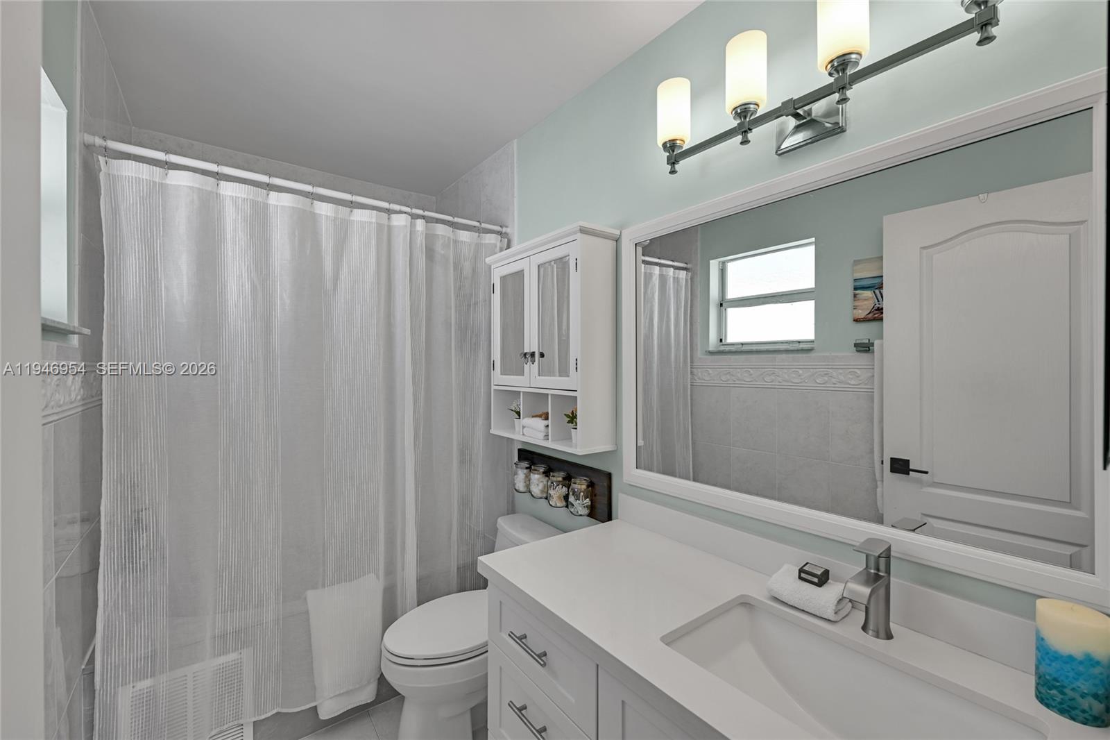 24955 Southwest 129th Path Homestead, FL 33032 - Photo 15 of 26 a bathroom with a sink a toilet and a mirror