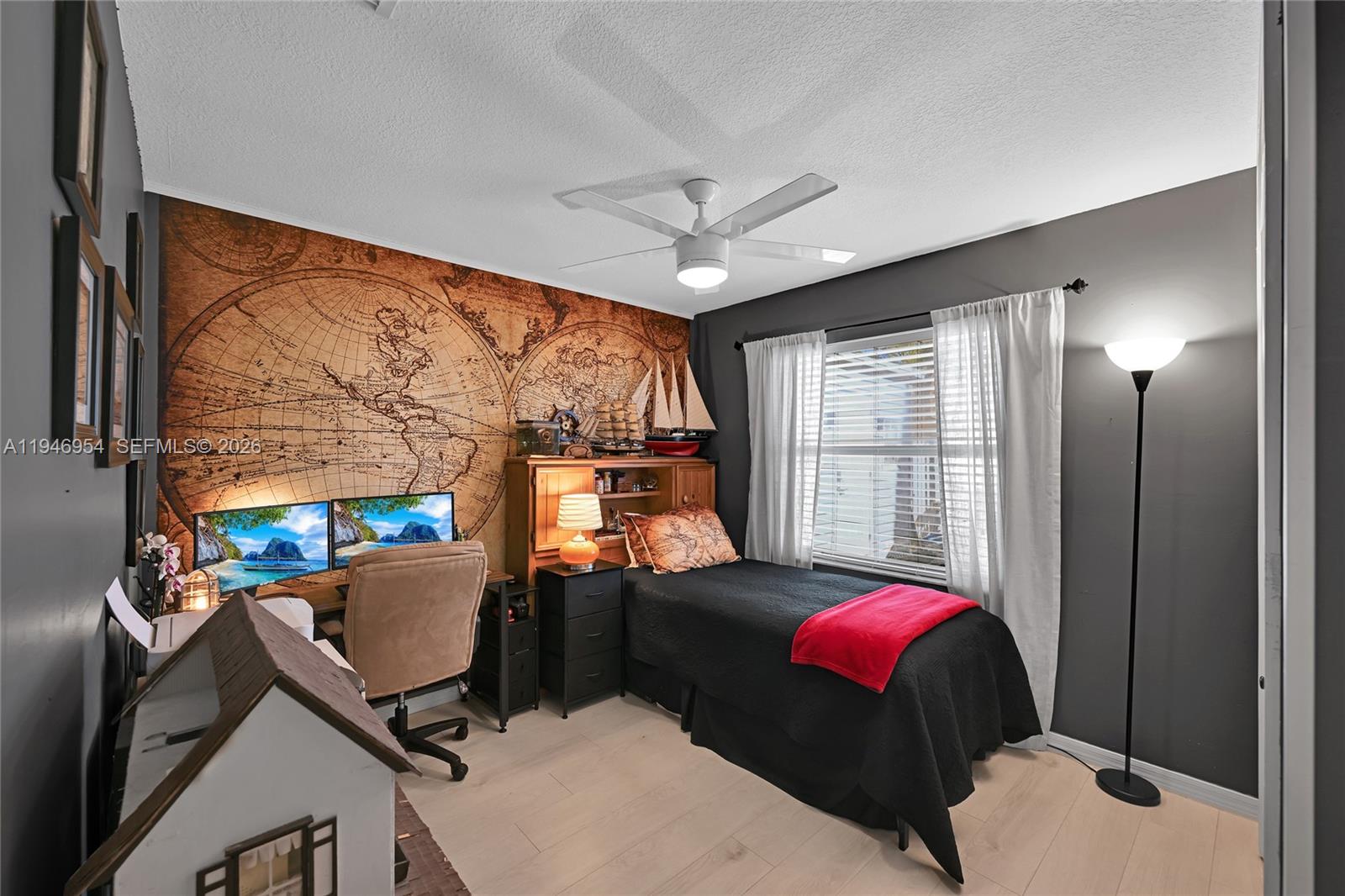 24955 Southwest 129th Path Homestead, FL 33032 - Photo 16 of 26 a living room with furniture a flat screen tv and a floor to ceiling window