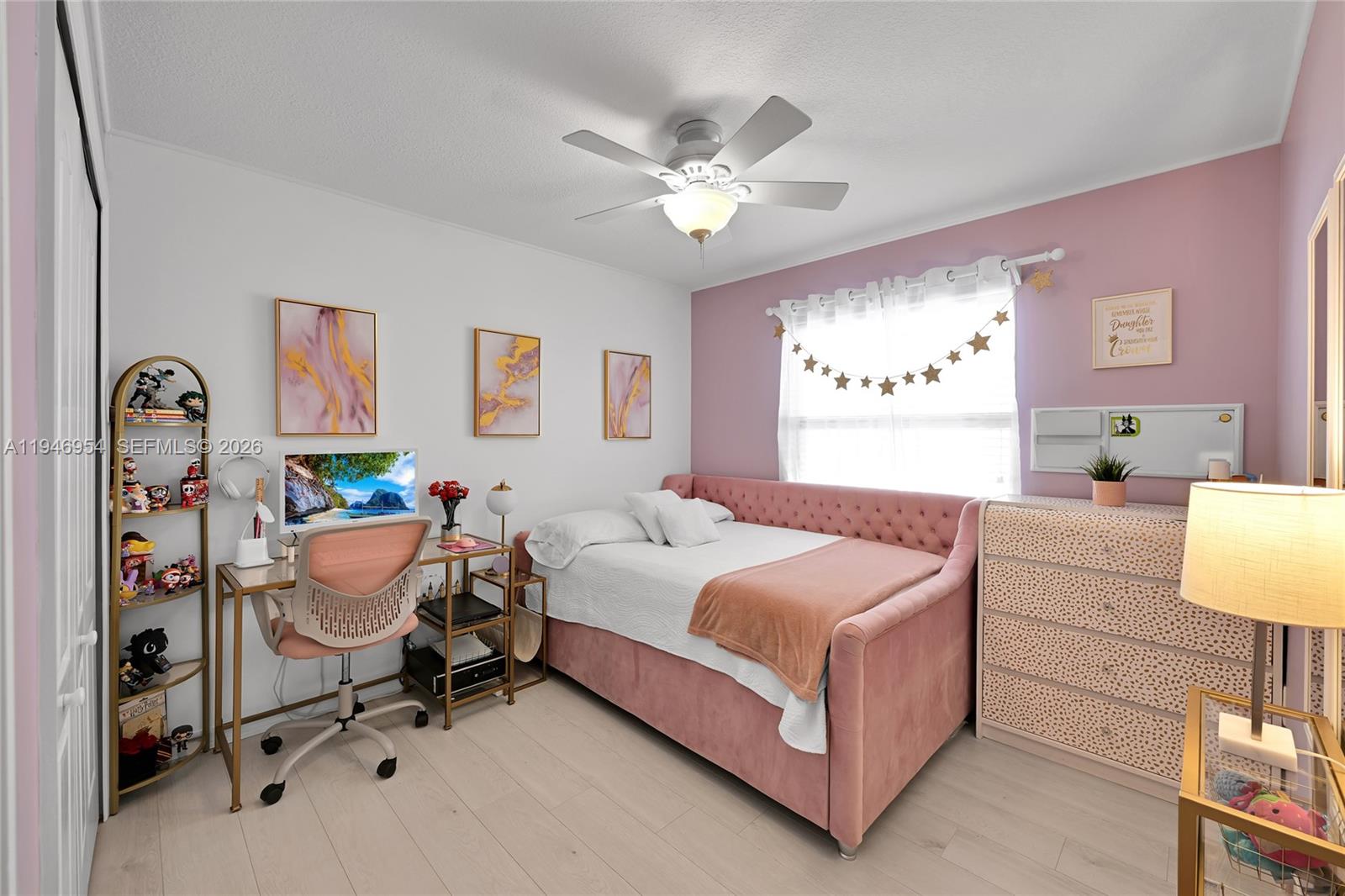 24955 Southwest 129th Path Homestead, FL 33032 - Photo 18 of 26 a bedroom with a bed and a chandelier