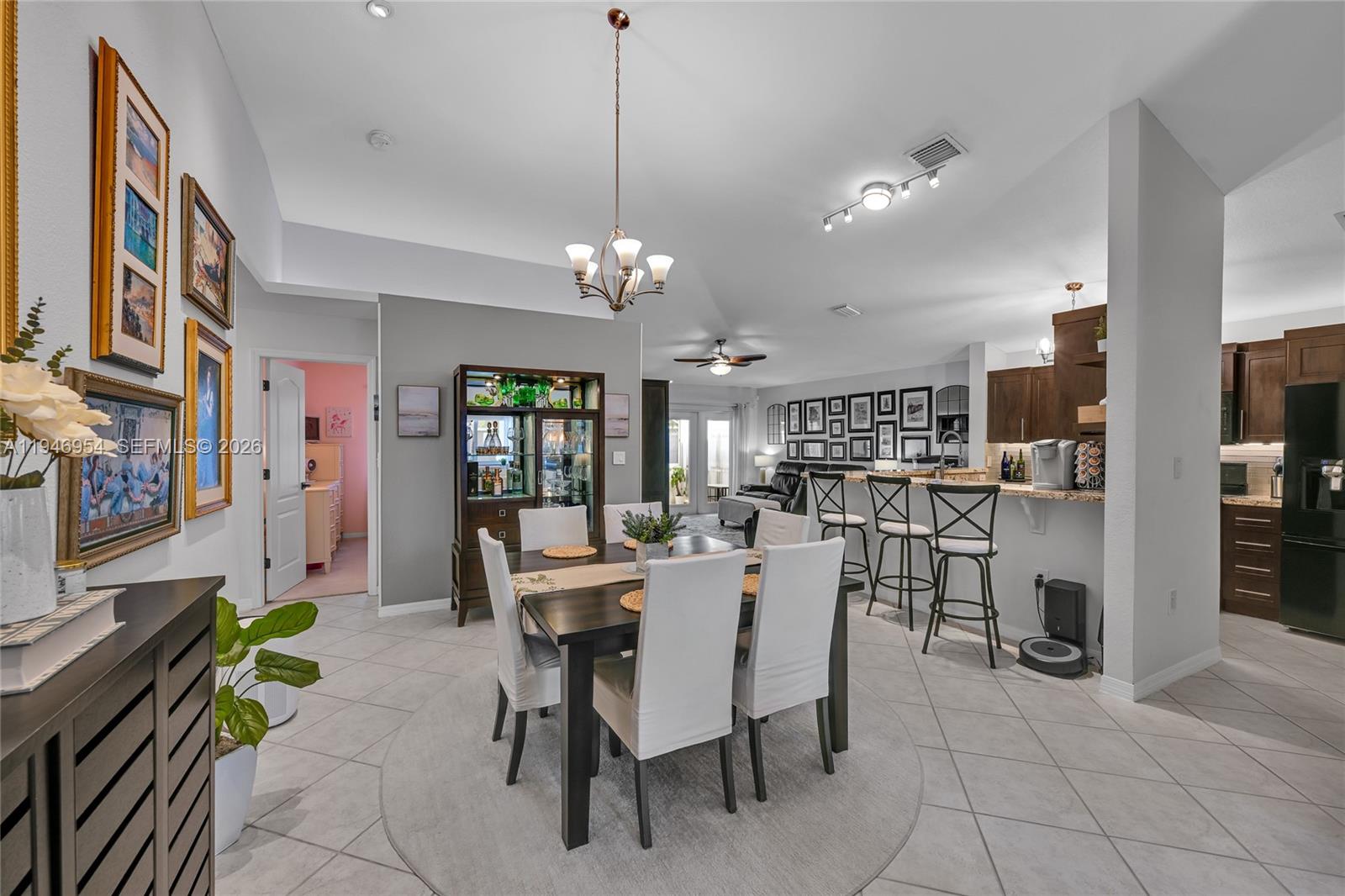 24955 Southwest 129th Path Homestead, FL 33032 - Photo 4 of 26 a view of a dining room with furniture and chandelier
