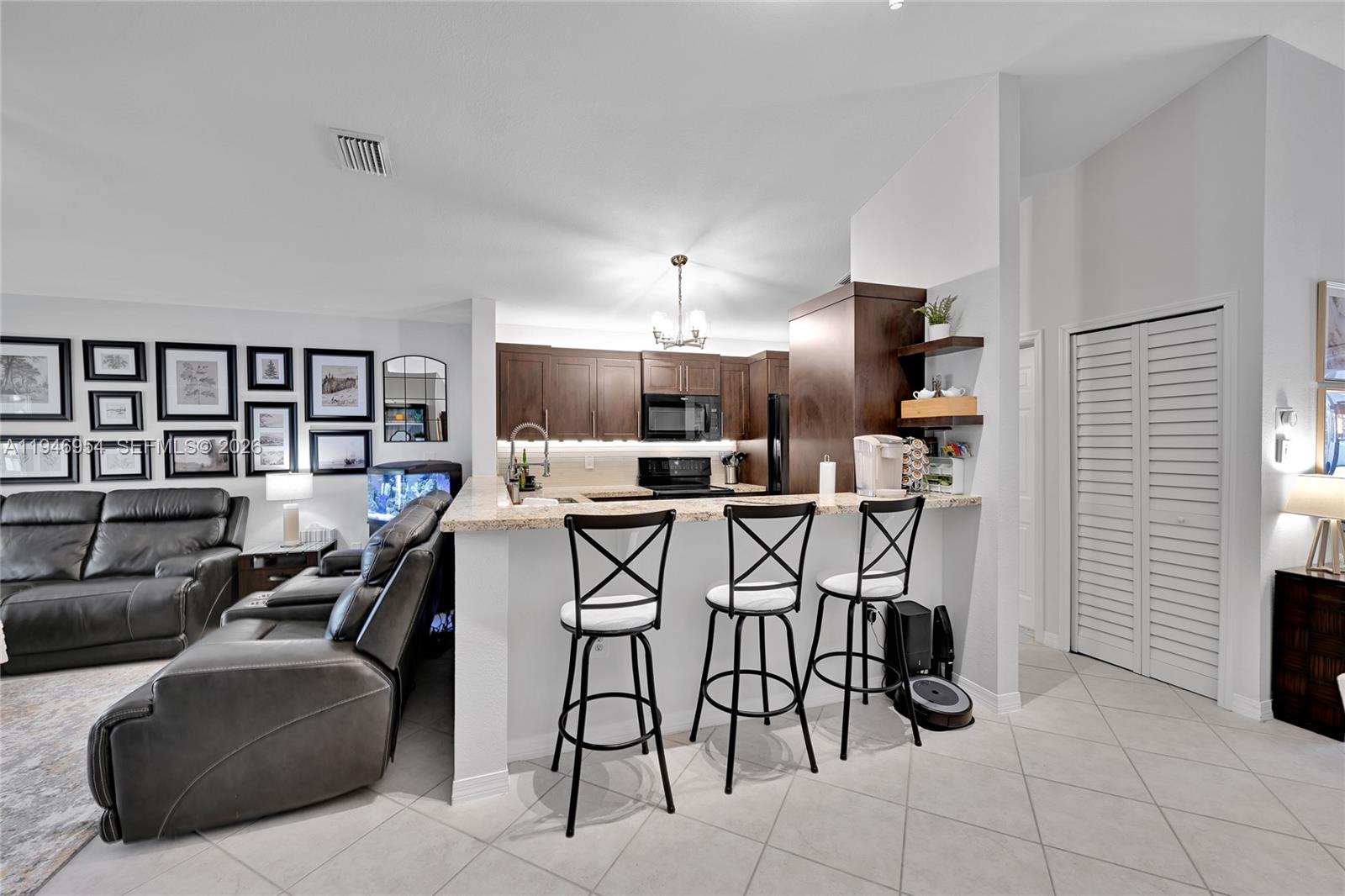 24955 Southwest 129th Path Homestead, FL 33032 - Photo 7 of 26 a living room with furniture a flat screen tv and a table