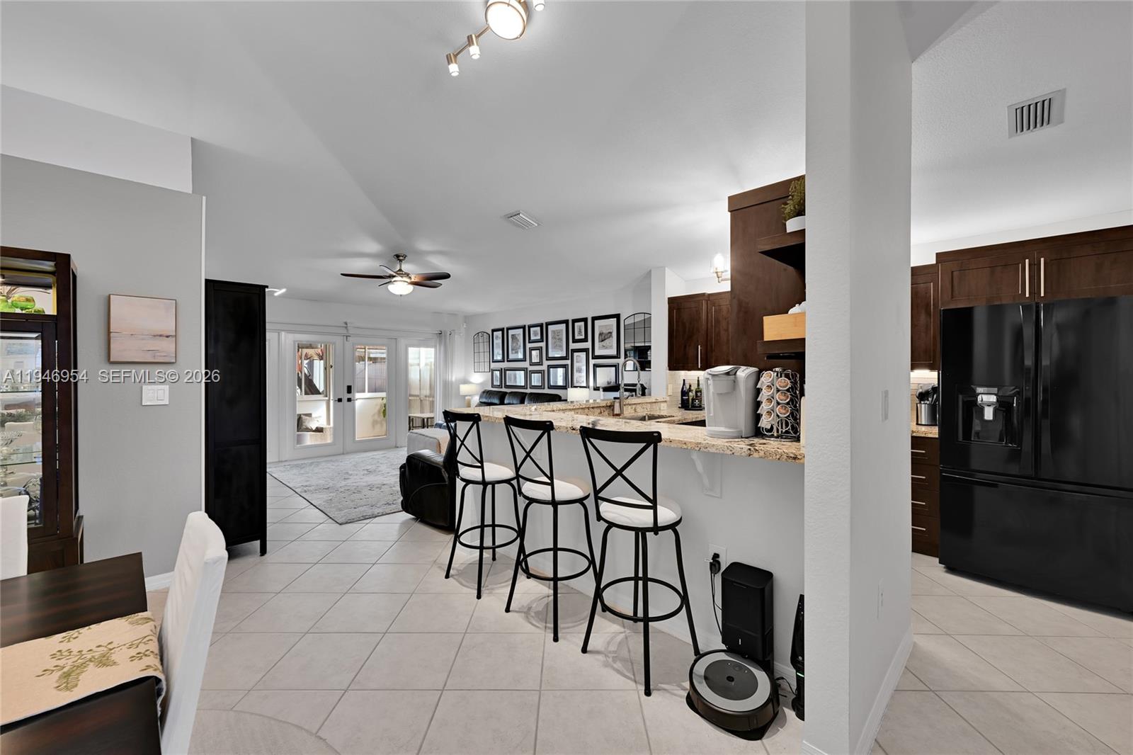 24955 Southwest 129th Path Homestead, FL 33032 - Photo 8 of 26 a view of a kitchen and dining room