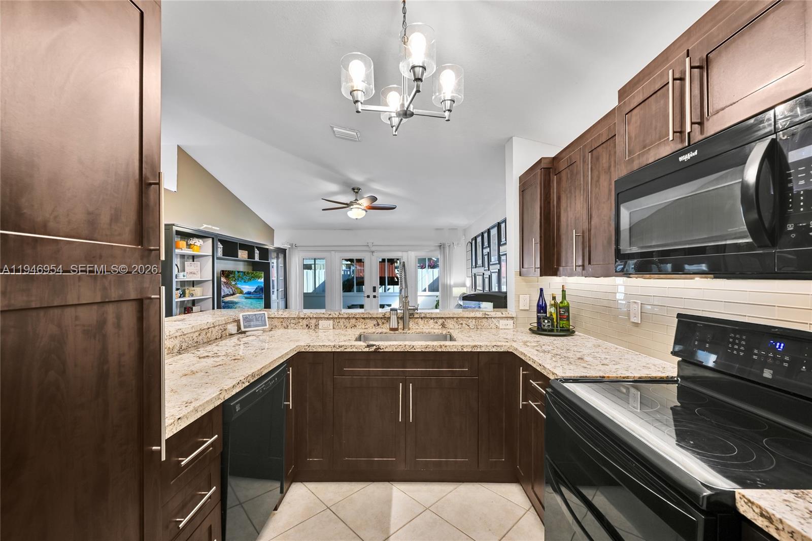 24955 Southwest 129th Path Homestead, FL 33032 - Photo 10 of 26 a kitchen with stainless steel appliances granite countertop a sink and stove top oven