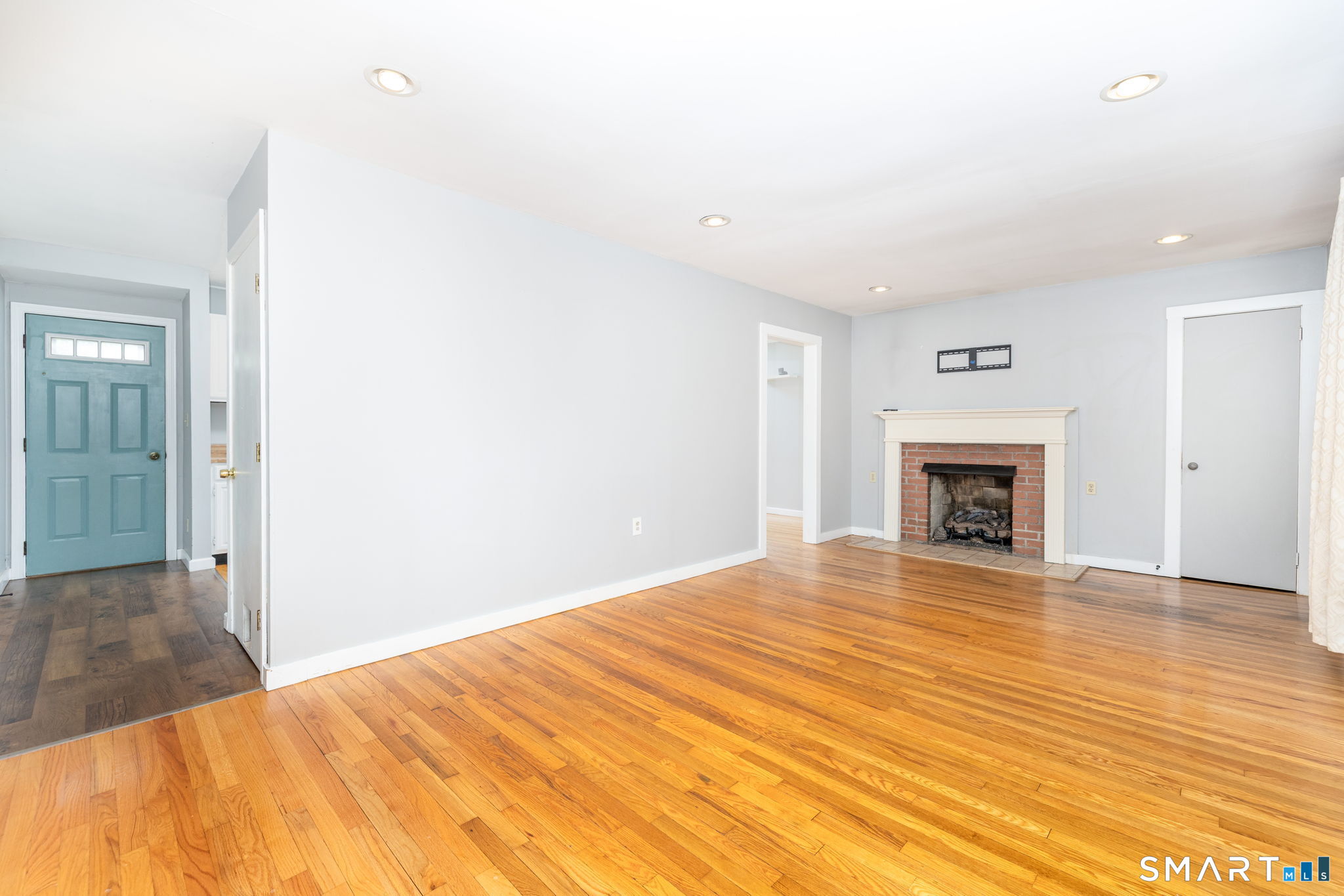 347 Griffin Road Suffield, CT 06093 - Photo 10 of 35 a view of empty room with wooden floor and fireplace