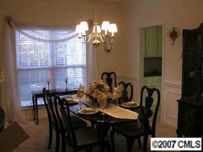 4118 Desert Rose Court Fort Mill, SC 29708 - Photo 5 of 8 a view of a dining room with furniture and chandelier