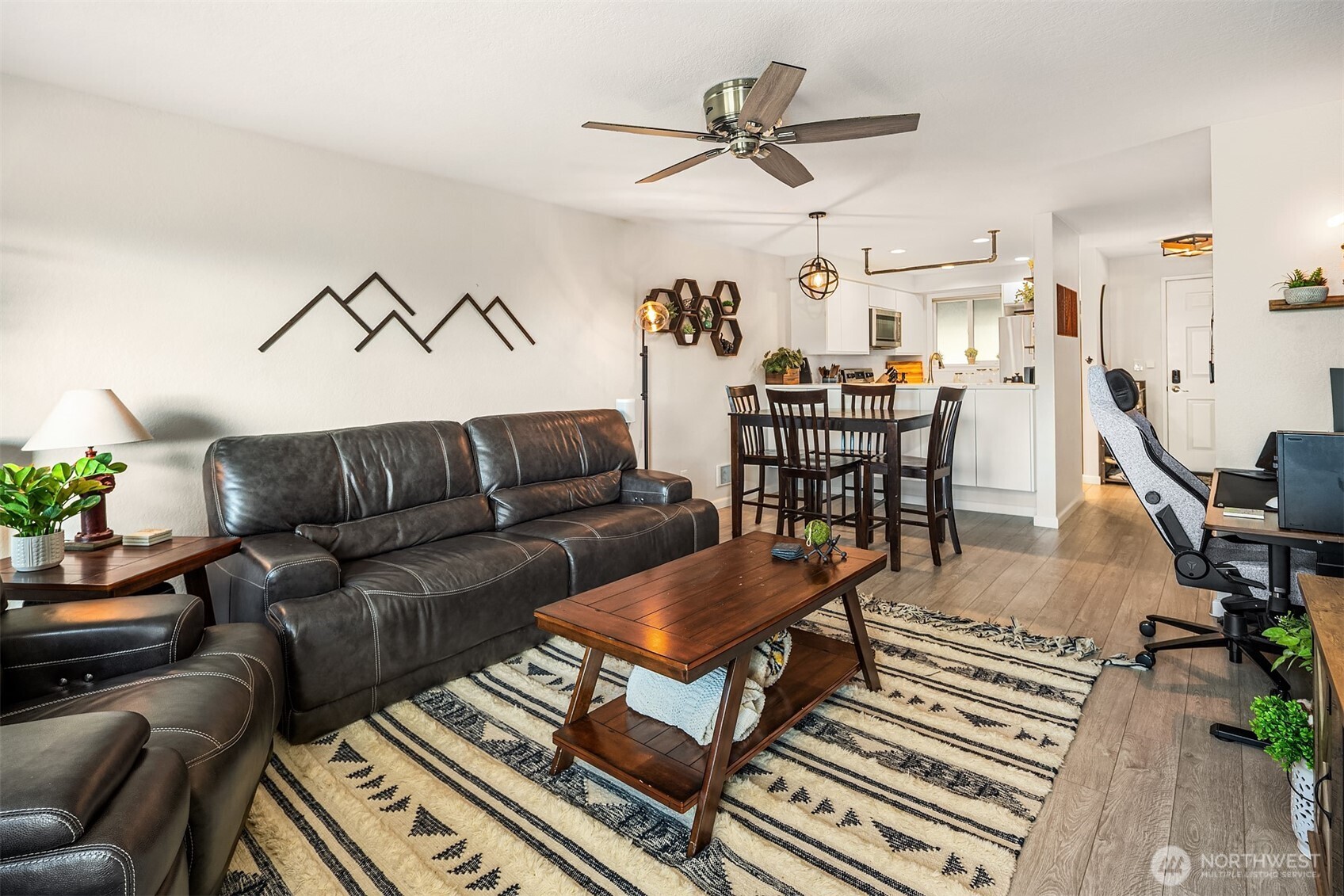4893 76th Street Southwest, Unit E1002 Mukilteo, WA 98275 - Photo 12 of 27 a living room with furniture a ceiling fan and a rug