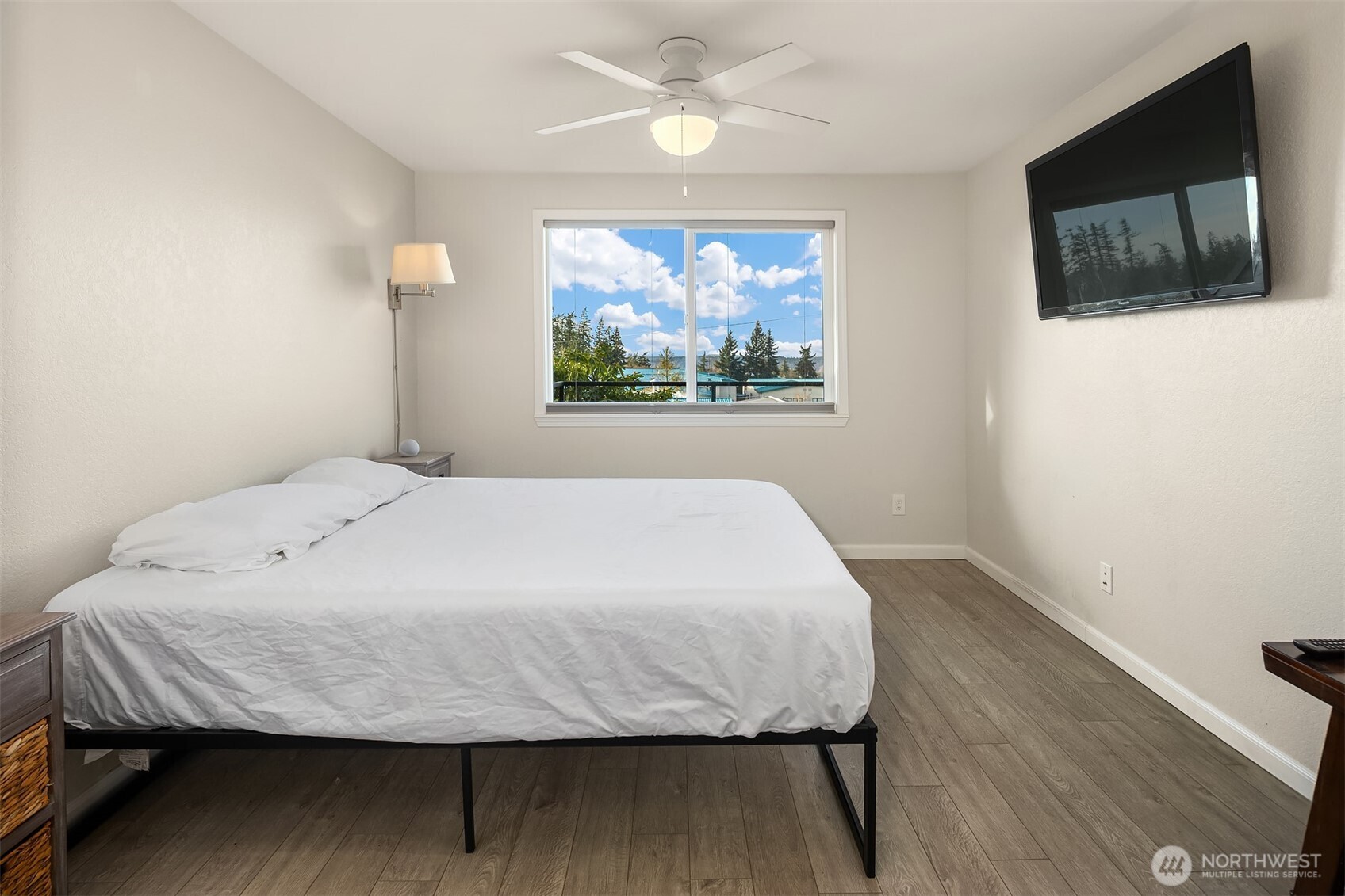 4893 76th Street Southwest, Unit E1002 Mukilteo, WA 98275 - Photo 17 of 27 a bed sitting in a bedroom next to a window