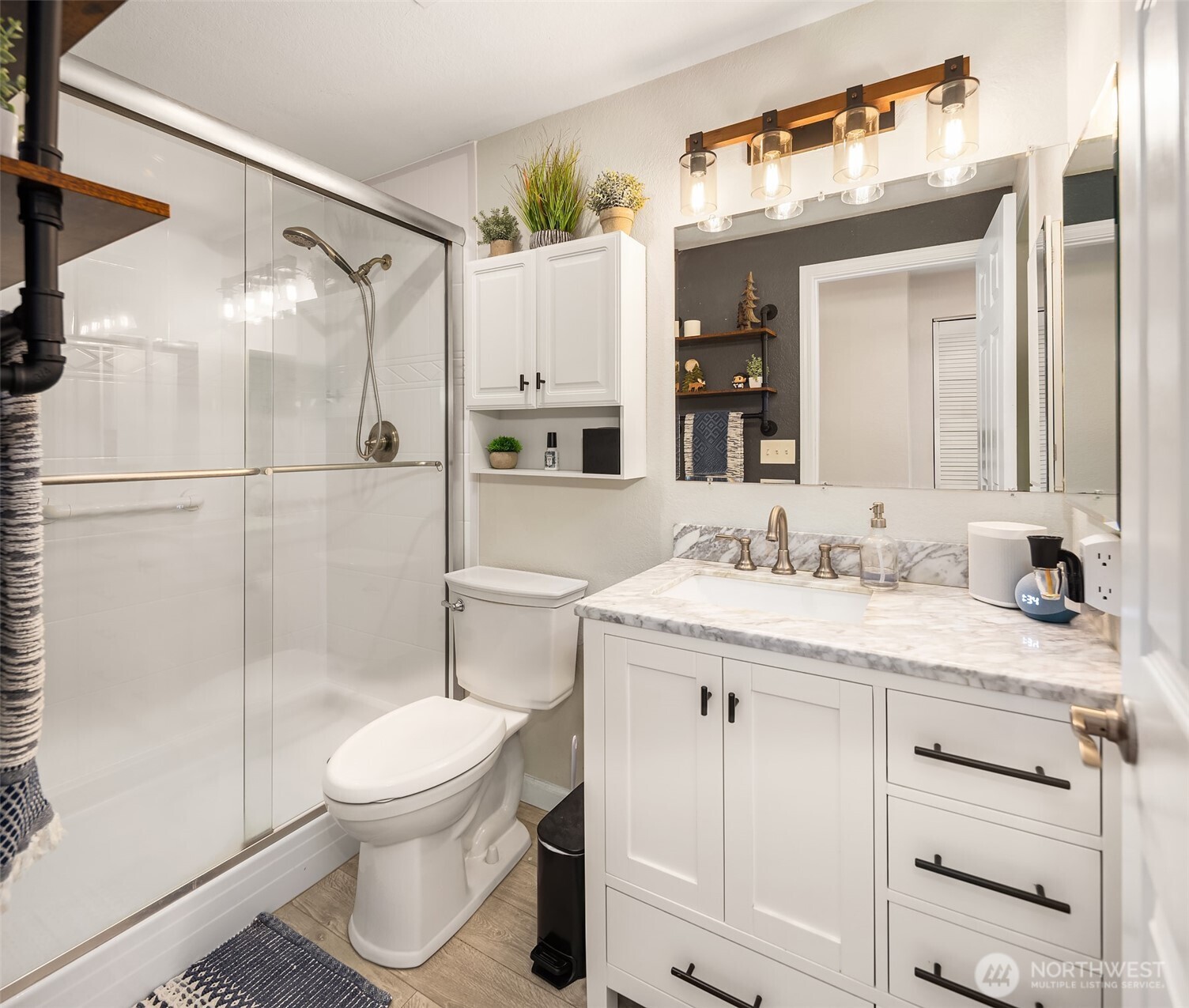 4893 76th Street Southwest, Unit E1002 Mukilteo, WA 98275 - Photo 18 of 27 a bathroom with a granite countertop sink toilet and shower