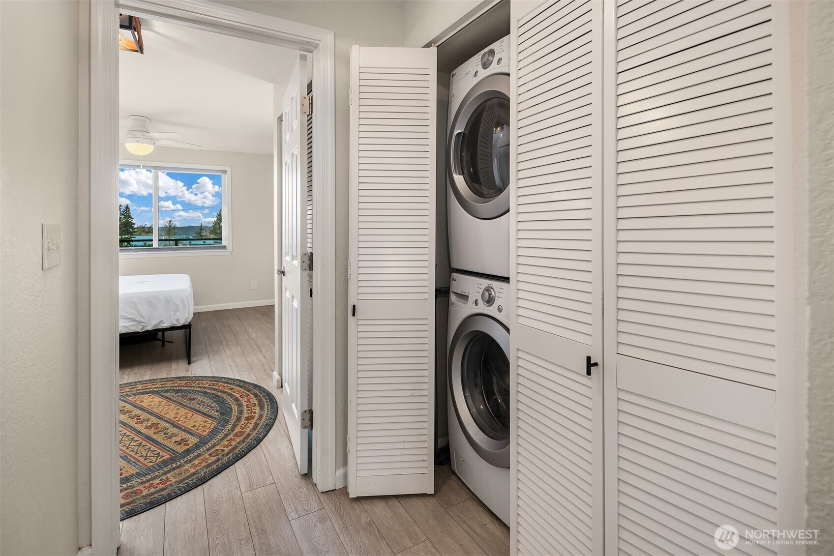 4893 76th Street Southwest, Unit E1002 Mukilteo, WA 98275 - Photo 20 of 27 a view of a hallway with washer and dryer