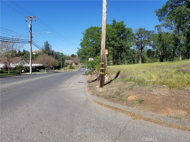 a view of a road with a bench in the background
