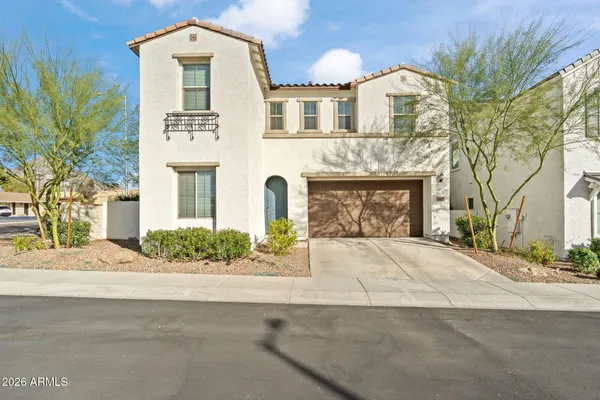 a front view of a house with a garden