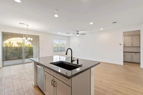 a kitchen with kitchen island a sink and a stove