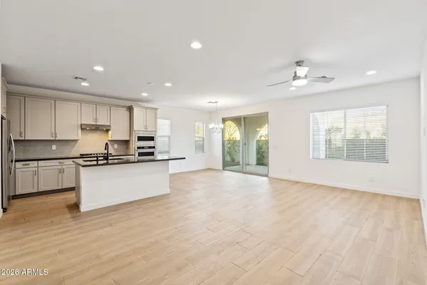 a large kitchen with stainless steel appliances granite countertop a large counter top a sink and a stove