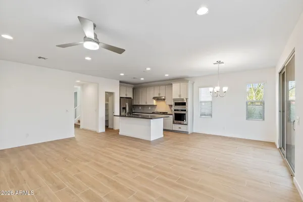 a view of kitchen with kitchen island stainless steel appliances refrigerator stove microwave and cabinets