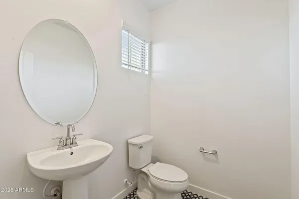 a bathroom with a sink a mirror and a toilet