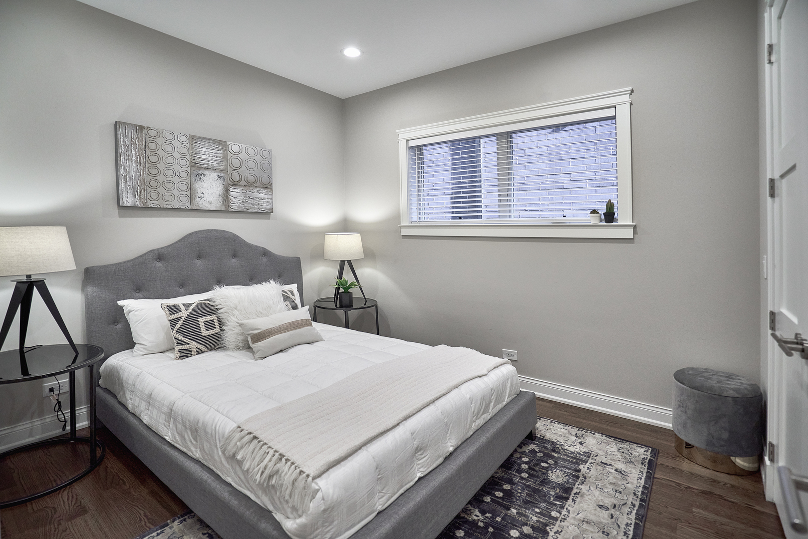 3044 North Racine Avenue, Unit 2 Chicago, IL 60657 - Photo 12 of 27 a bedroom with a bed and a lamp on dresser