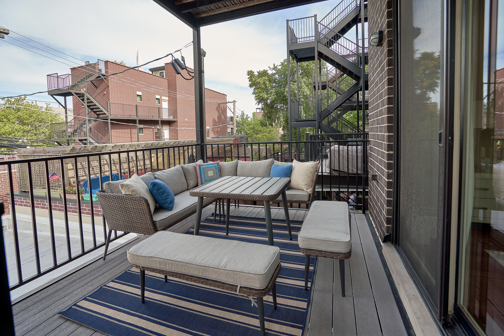 3044 North Racine Avenue, Unit 2 Chicago, IL 60657 - Photo 23 of 27 a balcony with wooden floor outdoor seating and city view
