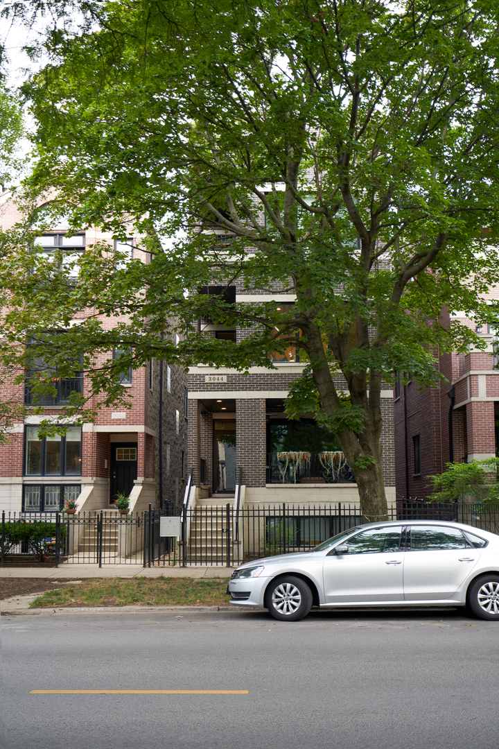 3044 North Racine Avenue, Unit 2 Chicago, IL 60657 - Photo 25 of 27 a car parked in front of a building