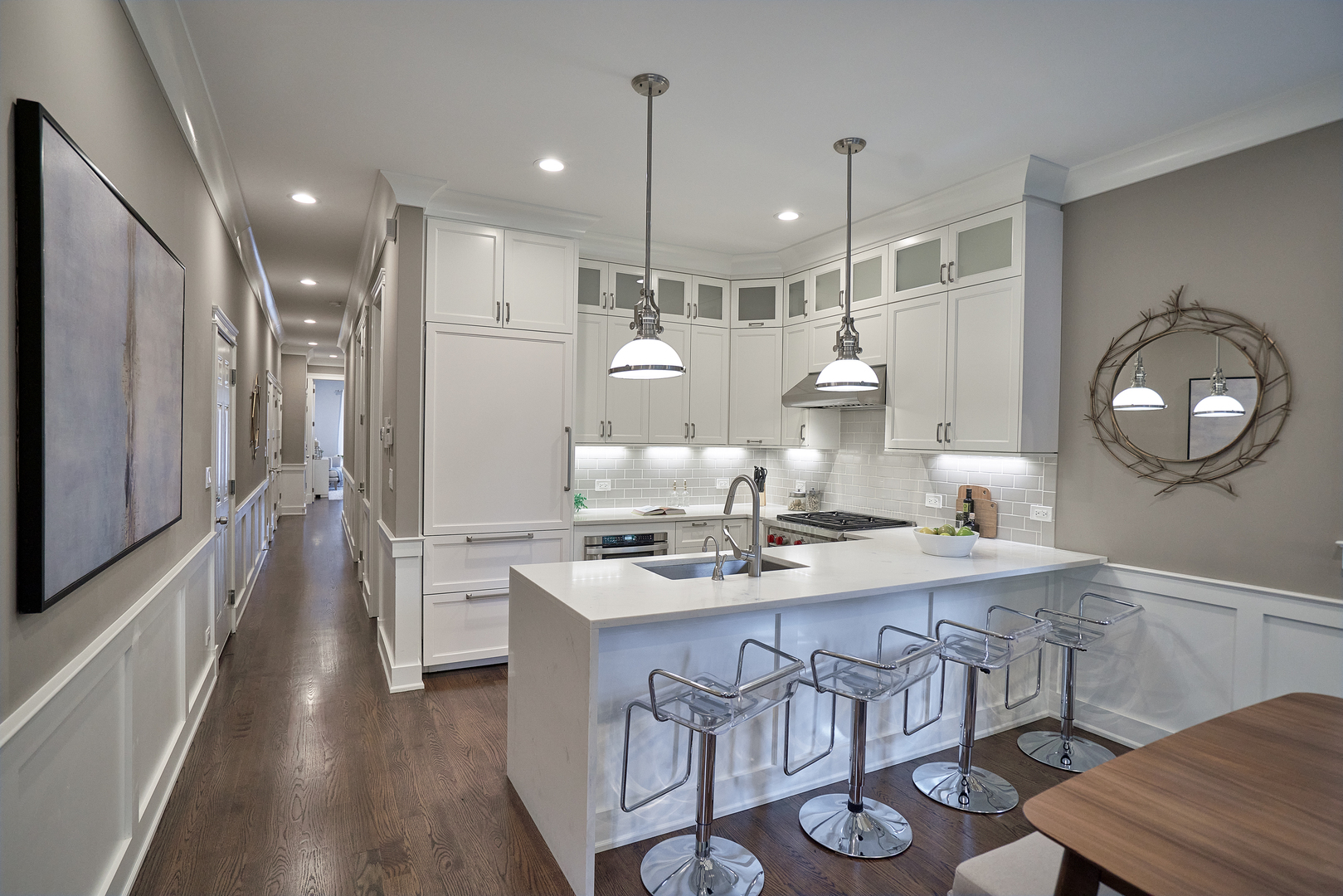 3044 North Racine Avenue, Unit 2 Chicago, IL 60657 - Photo 6 of 27 a kitchen with stainless steel appliances granite countertop a stove a kitchen island a dining table and chairs with wooden floor