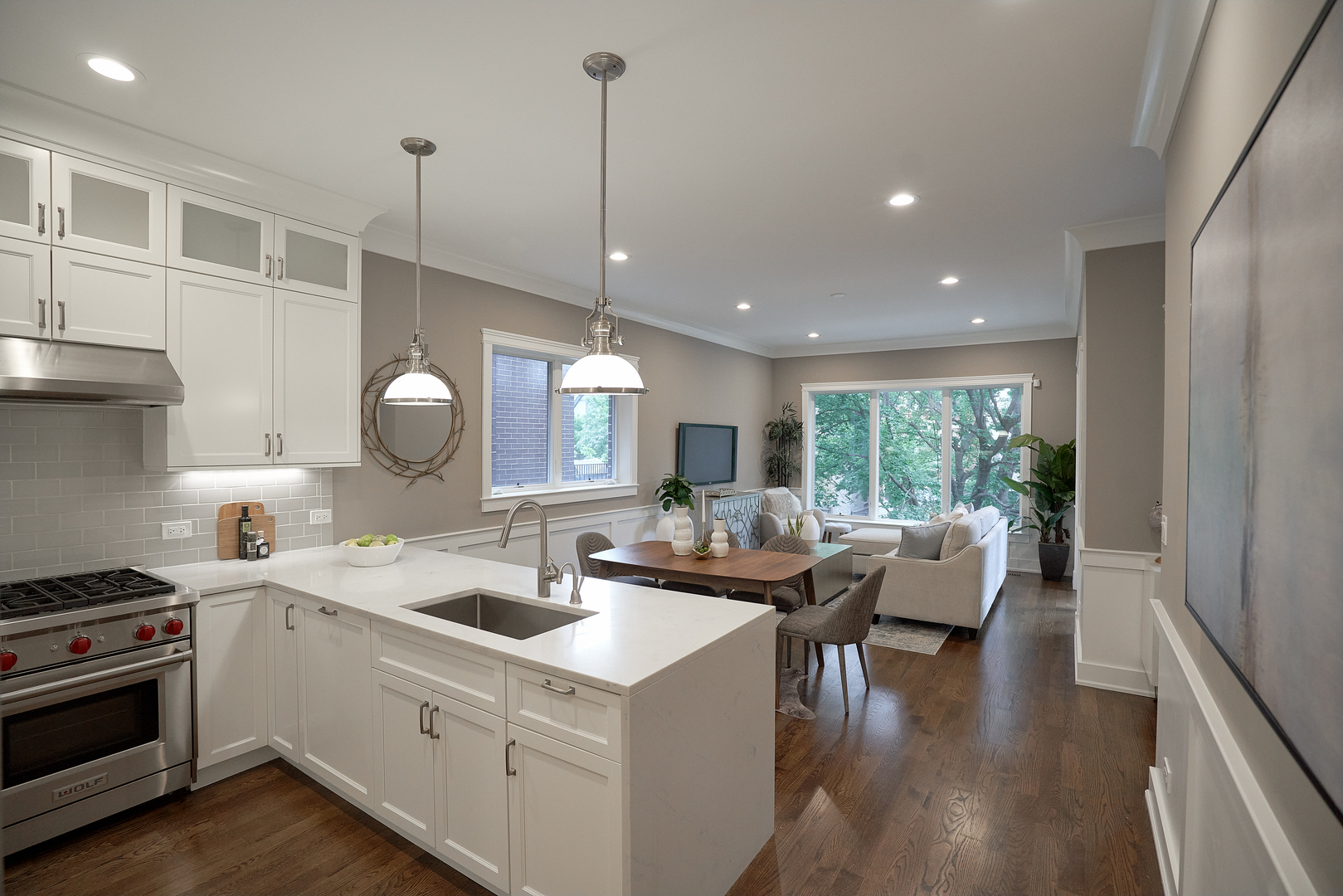 3044 North Racine Avenue, Unit 2 Chicago, IL 60657 - Photo 9 of 27 a open kitchen with stainless steel appliances granite countertop a sink a stove and a wooden floors