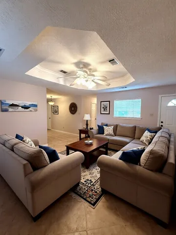 a living room with furniture and a large window