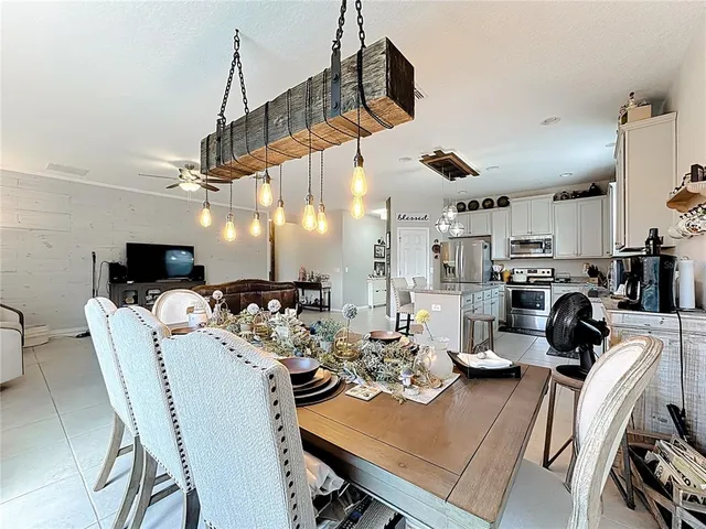 a living room with furniture and a ceiling fan