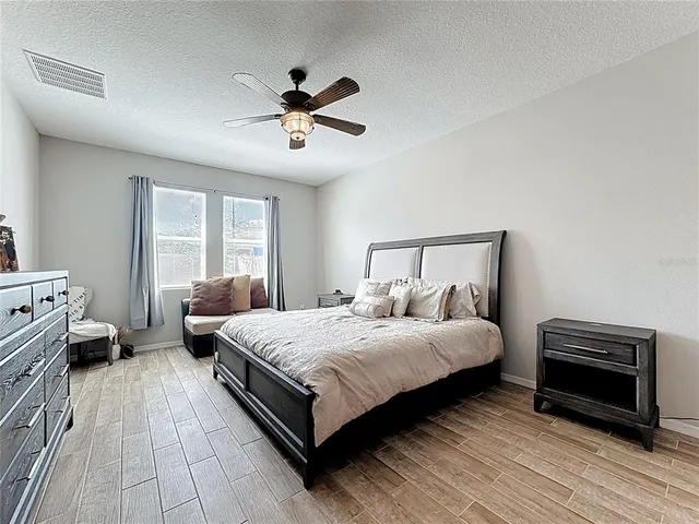 a bedroom with a bed and a television