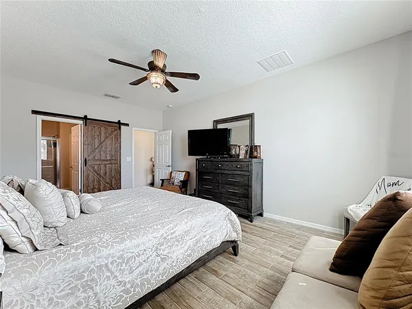 a bathroom with a granite countertop sink mirror vanity and toilet