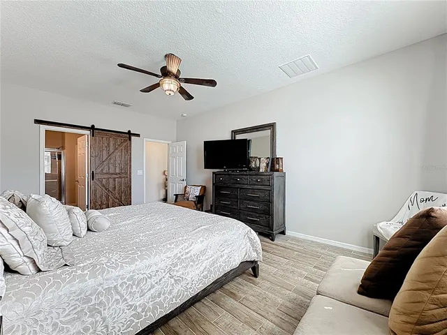 a bathroom with a granite countertop sink mirror vanity and toilet