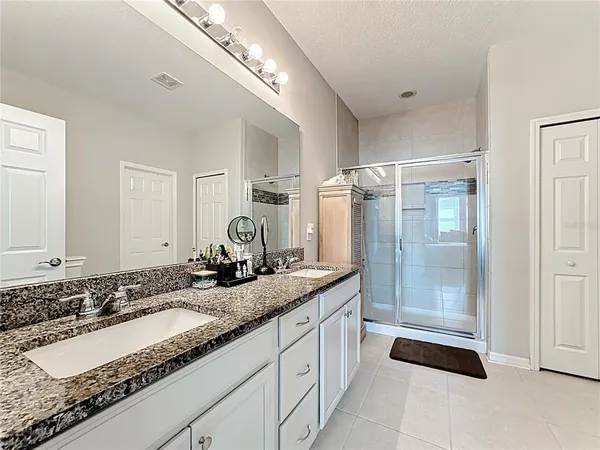 a bathroom with a granite countertop sink a toilet and a mirror