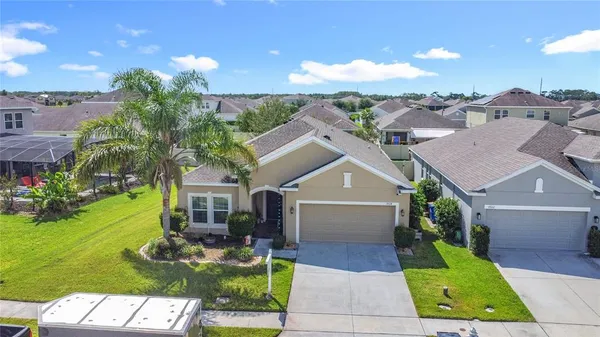 a view of house with swimming pool and front view of house