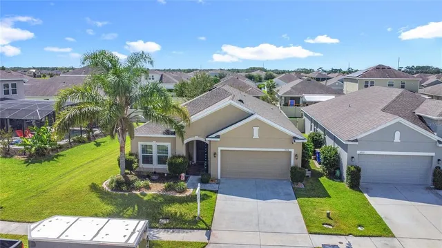 a view of house with swimming pool and front view of house