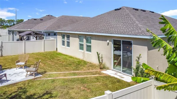 an aerial view of a house with a swimming pool outdoor seating and yard