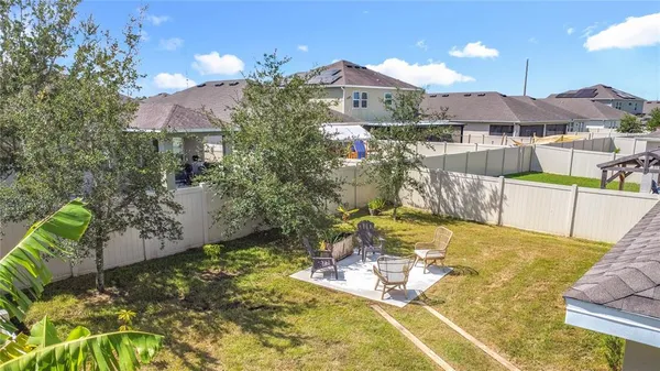 an aerial view of a house a swimming pool outdoor seating and outdoor space