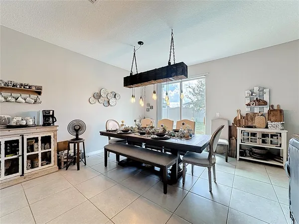 a kitchen with kitchen island granite countertop a sink a center island and stainless steel appliances