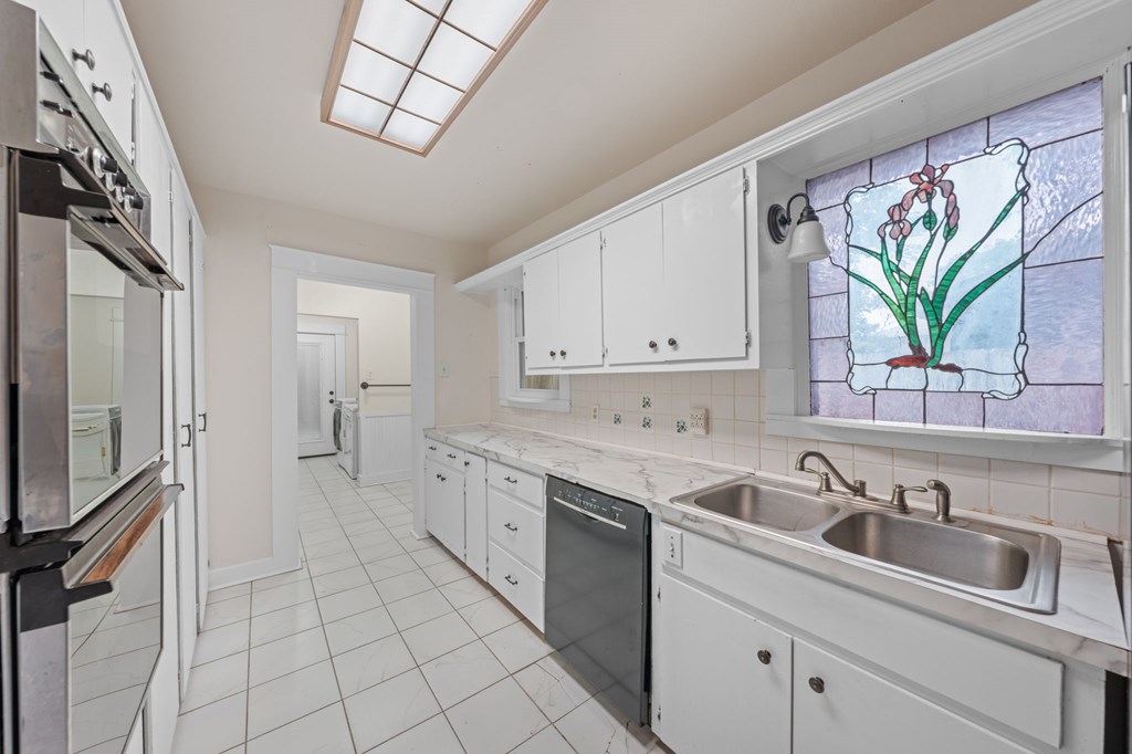 1209 Park Street Kerrville, TX 78028 - Photo 14 of 28 a kitchen with a sink cabinets and window