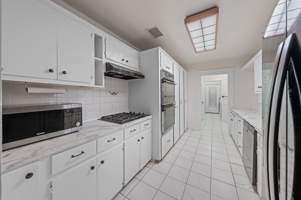 1209 Park Street Kerrville, TX 78028 - Photo 15 of 28 a kitchen with cabinets and a stove