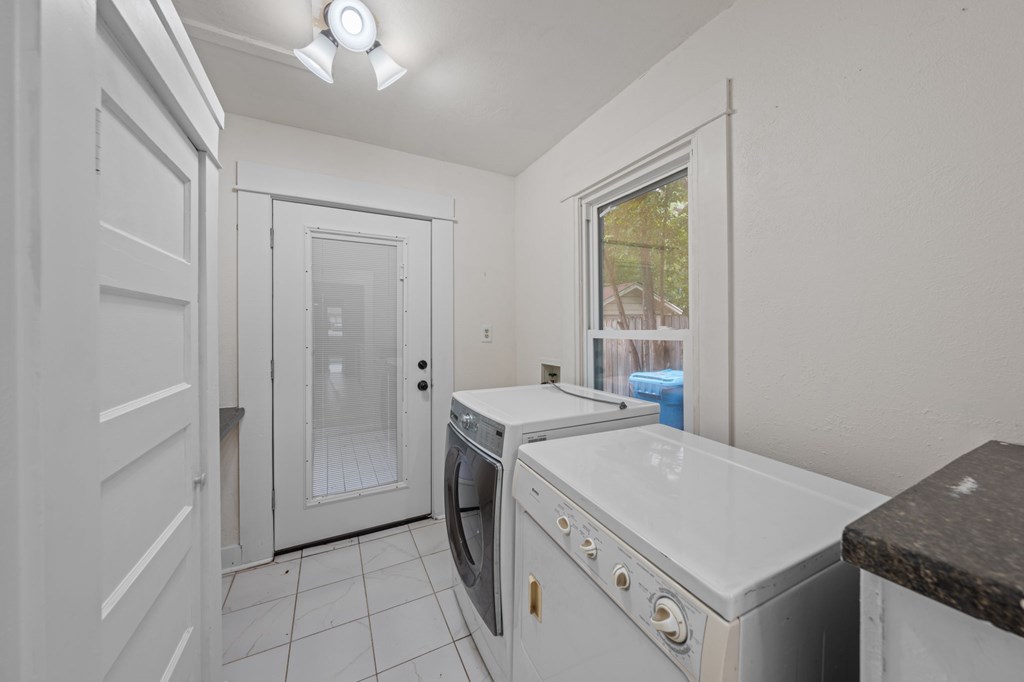 1209 Park Street Kerrville, TX 78028 - Photo 17 of 28 a utility room with cabinets washer and dryer