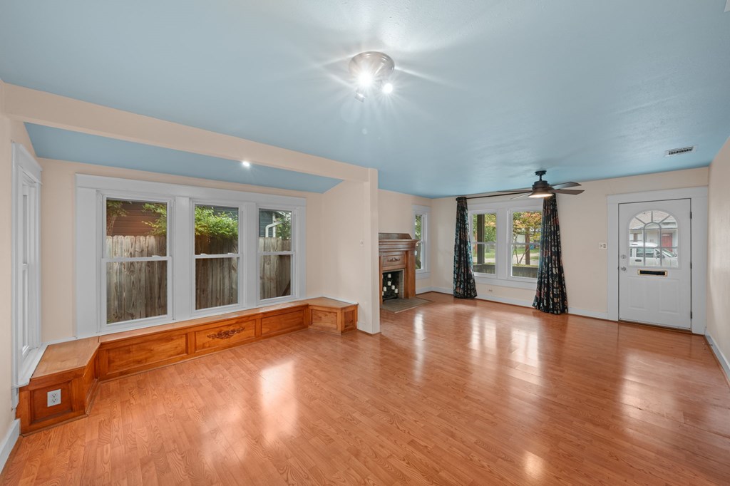 1209 Park Street Kerrville, TX 78028 - Photo 9 of 28 a view of an empty room with wooden floor and a window