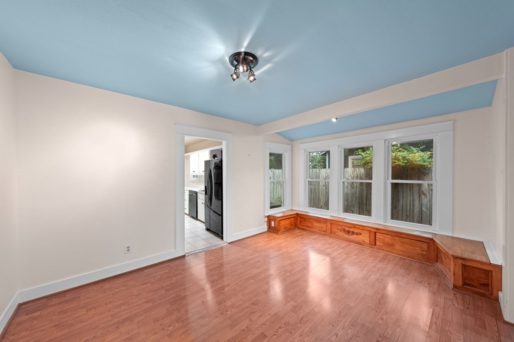 1209 Park Street Kerrville, TX 78028 - Photo 10 of 28 a view of an empty room with a window and wooden floor
