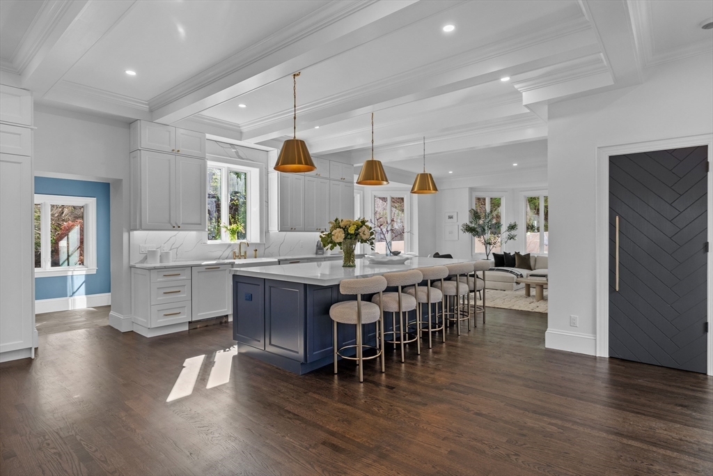 3 Myopia Road Winchester, MA 01890 - Photo 9 of 42 a kitchen with stainless steel appliances kitchen island granite countertop a table chairs and a refrigerator