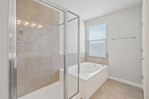 a white bath tub sitting next to a shower