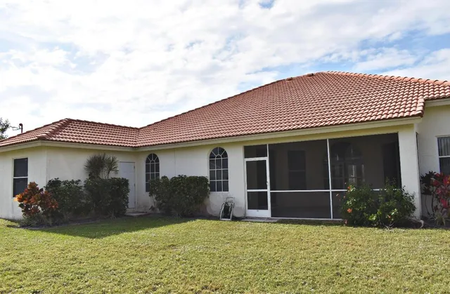 a view of a house with a yard and a large window