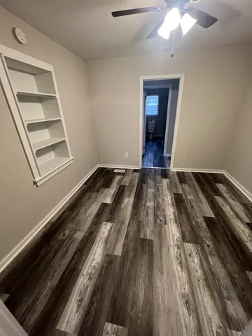 a view of a room with wooden floor and staircase