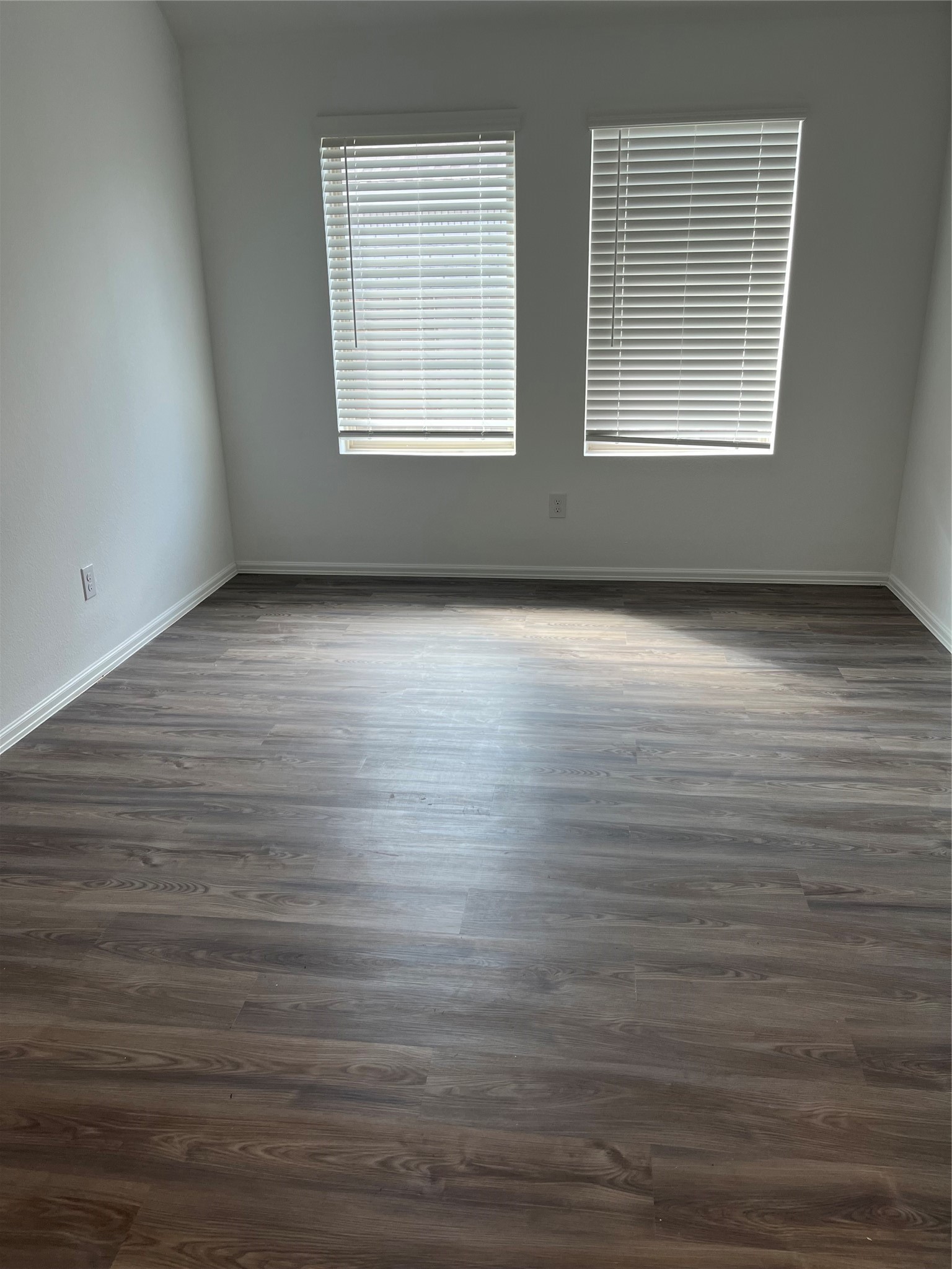3712 River Sand Road Rosenberg, TX 77469 - Photo 5 of 13 an empty room with wooden floor and windows
