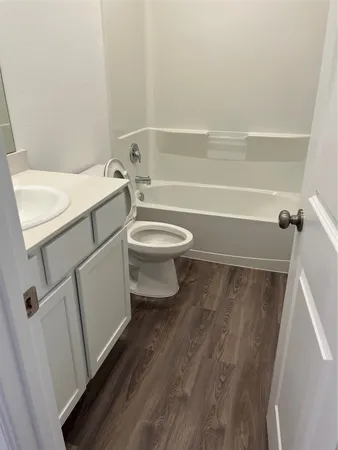 a bathroom with a toilet sink and vanity